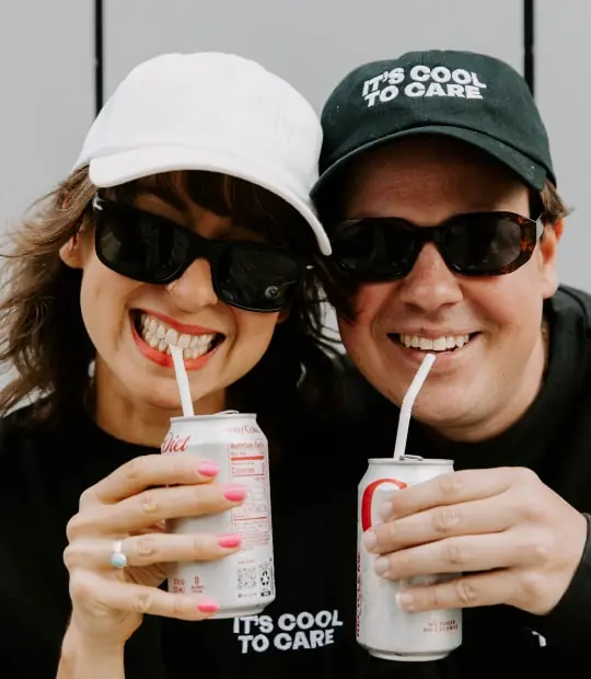 A man and woman smiling while holding a can of soda, representing the positive impact of digital marketing on branding.